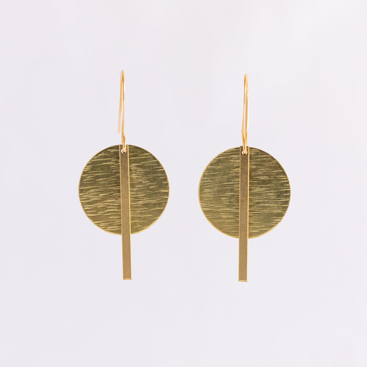 The Gaze of the Goddess Earrings: brass, flat stick backed by a flat textured disc, fininshed with french hooks.