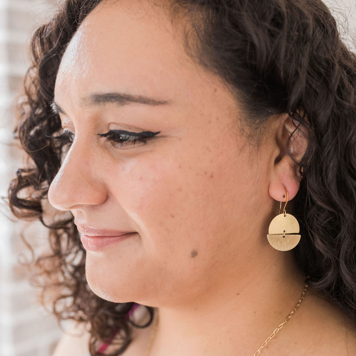 Woman modeling the Moon and Earth Earrings.